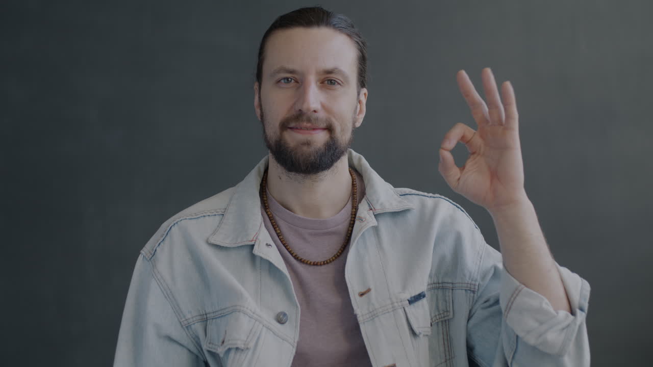 Man wearing a jeans jacket and smiling