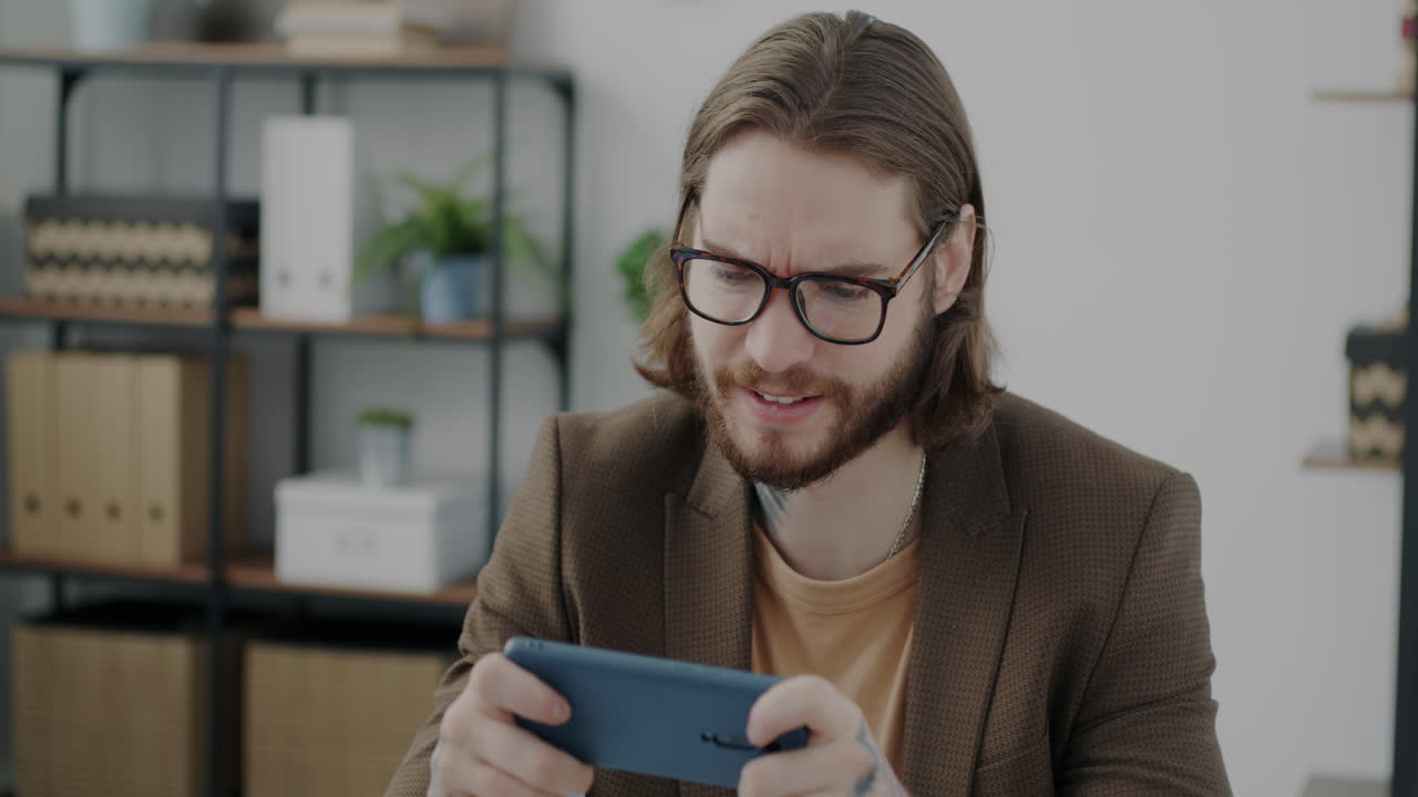Man playing games on phone and tablet