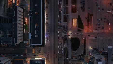 Aerial-birds-eye-overhead-top-down-panning-view-of-traffic-in-evening-street.-Queue-of-cars-in-front-crossroad.-Warsaw,-Poland