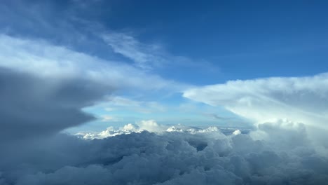 An-unique-pilot’s-point-of-view-while-flying-between-menacing-storm-clouds,-at-12000m-high,-with-a-deep-blue-sky