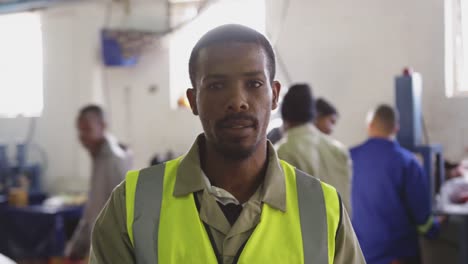 front view of mixed race worker in factory