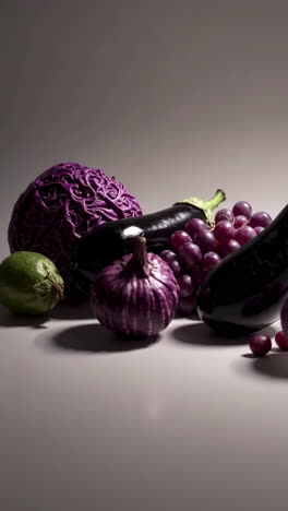 a still life arrangement of various purple vegetables and fruits