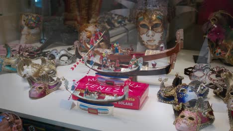 venetian mask and gondola miniatures display in shop window, italy