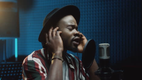 Close-Up-Of-The-Young-Handsome-And-Stylish-Male-Singer-Recording-A-Song-And-Singing-In-The-Mic-At-The-Sound-Studio