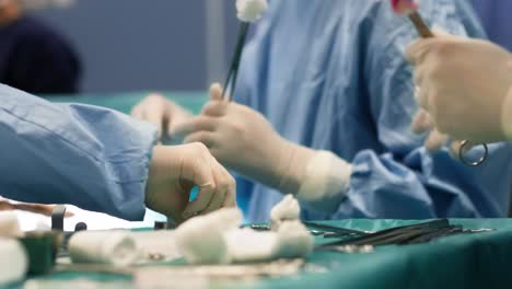 Busy-surgeons-passing-scissors-to-each-other-during-an-operation