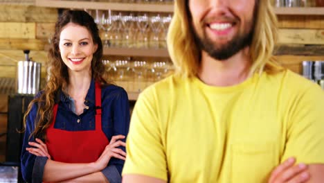 Portrait-of-waitress-and-costumer-standing-at-counter