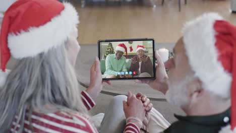 Happy-diverse-senior-couples-having-christmas-tablet-video-call,-slow-motion