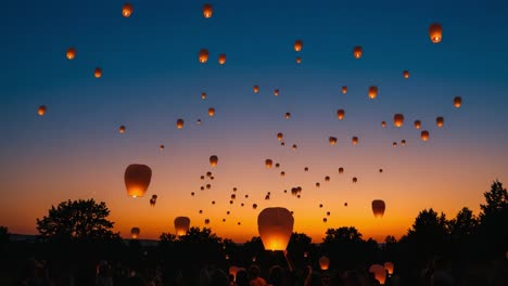 a majestic evening sky illuminated by floating lanterns against a colorful sunset, capturing the beauty and serenity of a magical night celebration