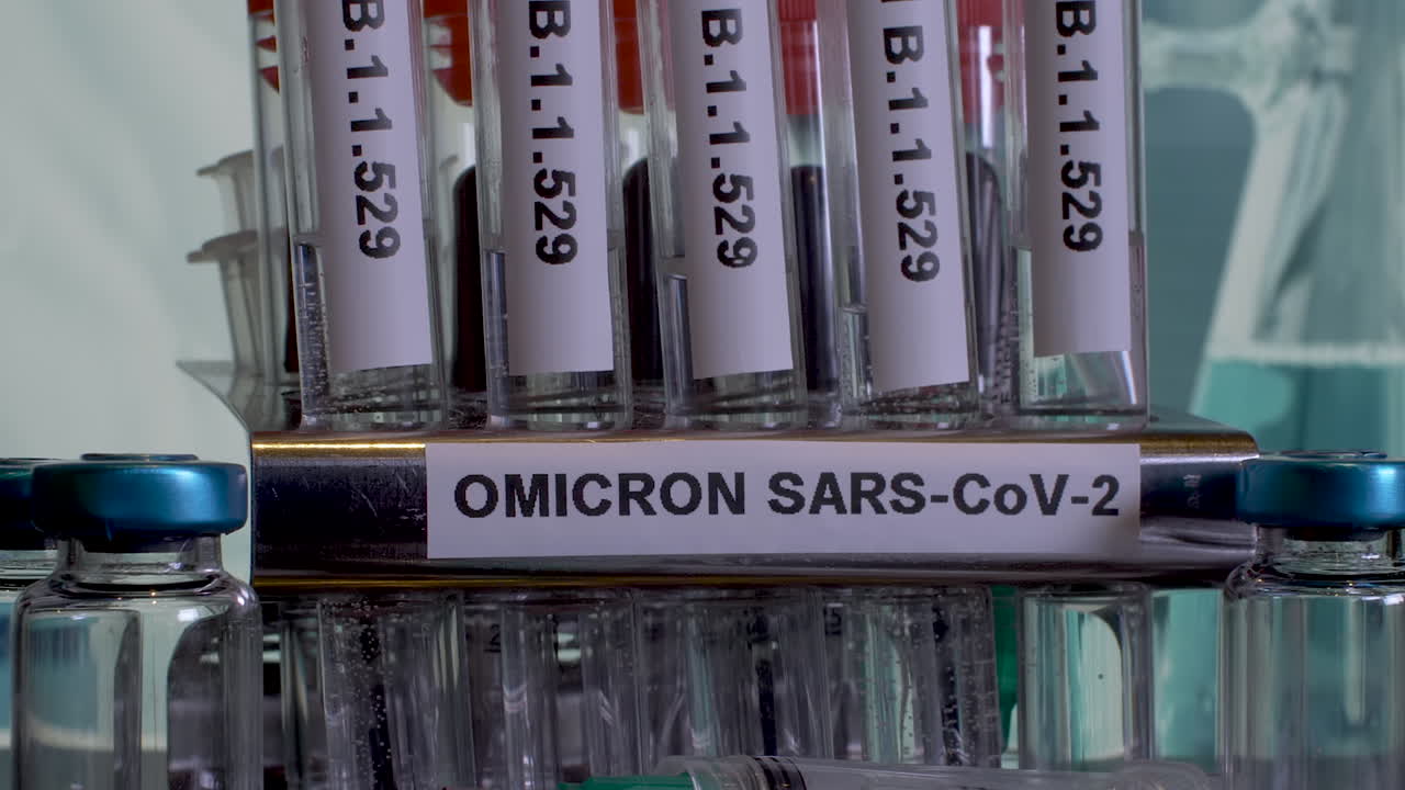Close up pan shot of test tubes labelled Omicron in a research laboratory, the outbreak of the new Covid 19 variant B.1.1.529 from South Africa