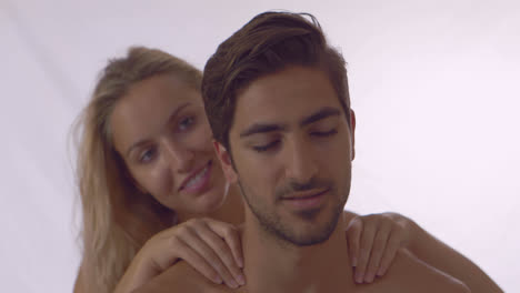 Blonde-giving-her-boyfriend-a-shoulder-rub