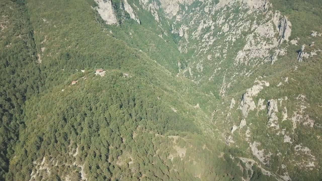 Aerial view of a mountain landscape with forests and rocks