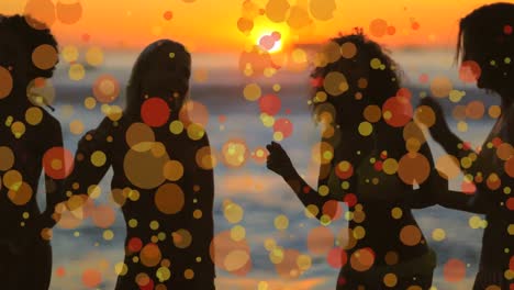 Women-dancing-on-the-beach-against-bokey-effect