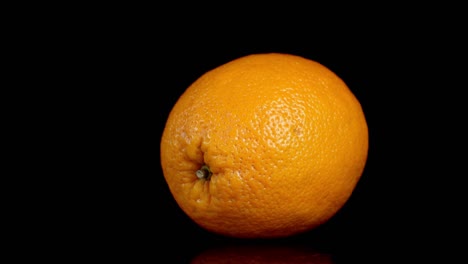 single ripe orange slowly rotates.