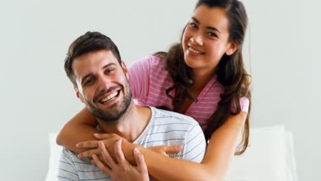 Portrait-of-couple-embracing-each-other-in-bedroom