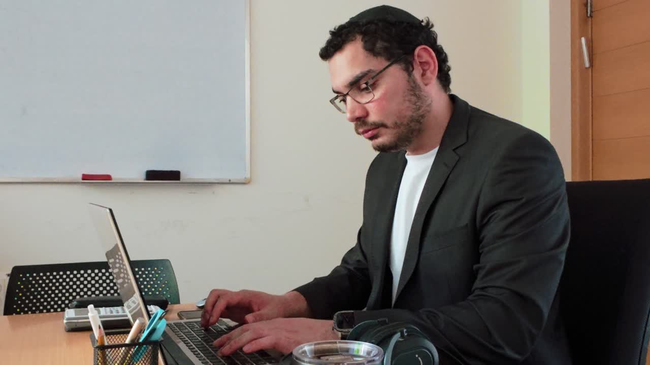 Young Entrepreneur Focused on Laptop