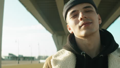 portrait of young handsome man in streetwear outdoors