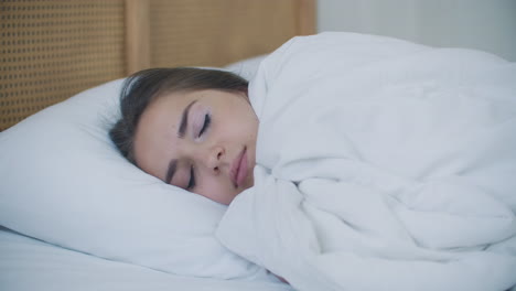 attractive brunette woman in pajamas lying in bed sleepless insomnia.