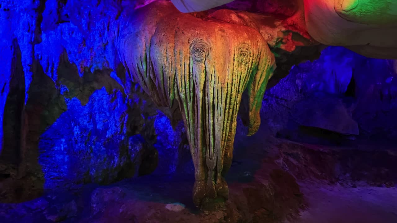A Beam of Vibrant Light Casting Hues Over a Limestone Formation Resembling an Elephant at Kek Look Tong Cave in Ipoh, Malaysia - Close Up