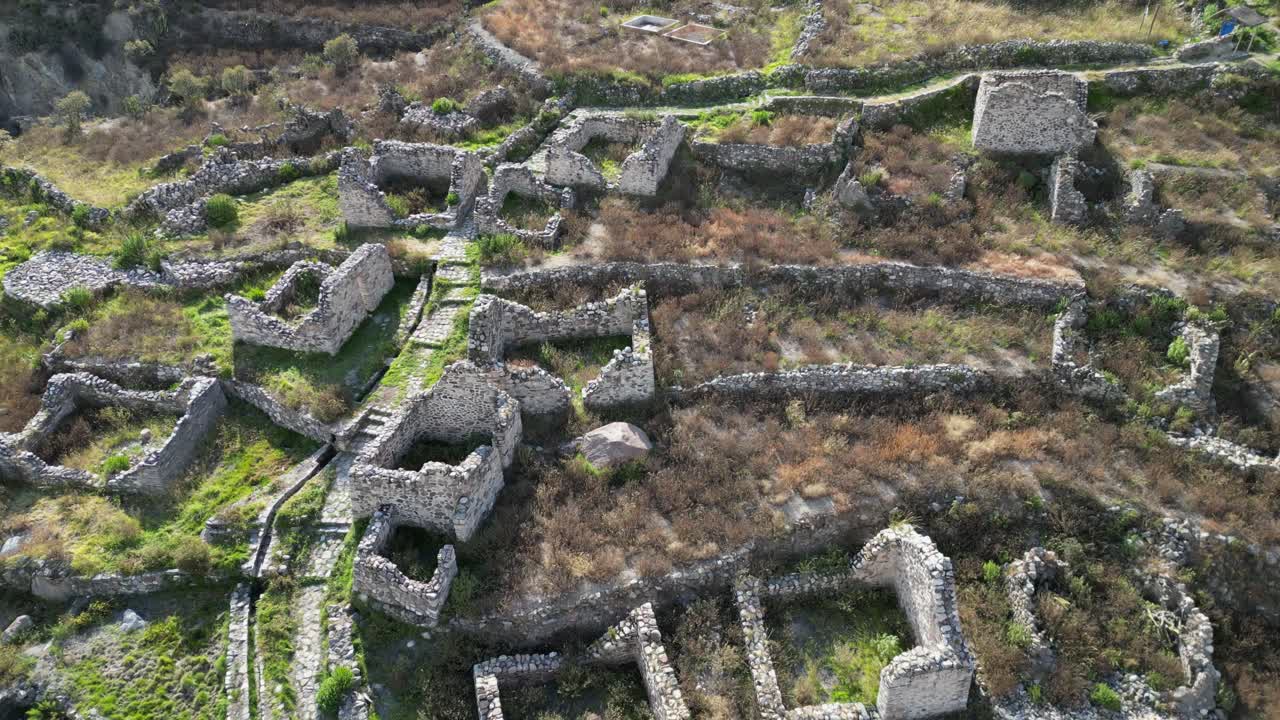 Flyover old stone building ruins of Uyo Uyo cemetery in southern Peru