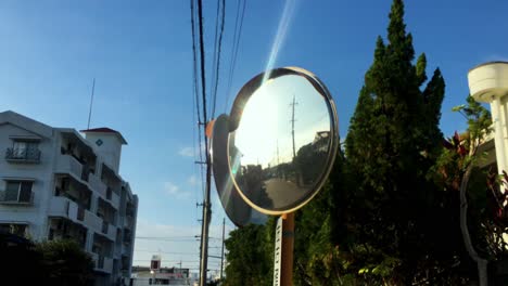 roadside mirror with morning sunlight glare in the reflection