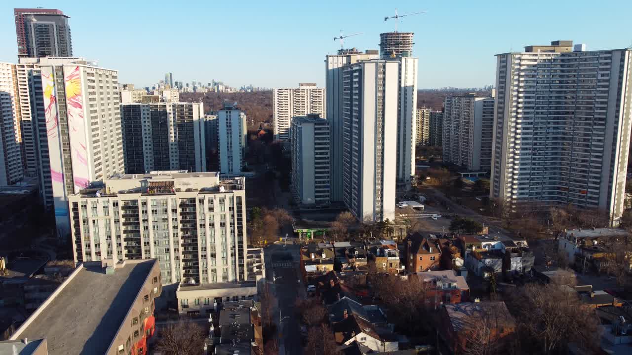 4k descending drone shot of Saint James Town neighborhood in downtown Toronto with a view of North York on the horizon.