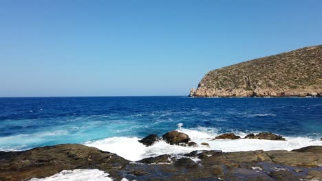 slowmotion shot from the naxos shoreline watching the waves crash against the rocks