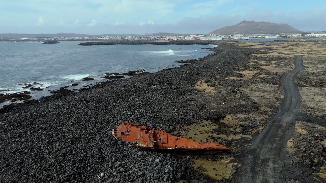 Grindavik Iceland aerial footage of beach near the fisherman town with abandoned boat