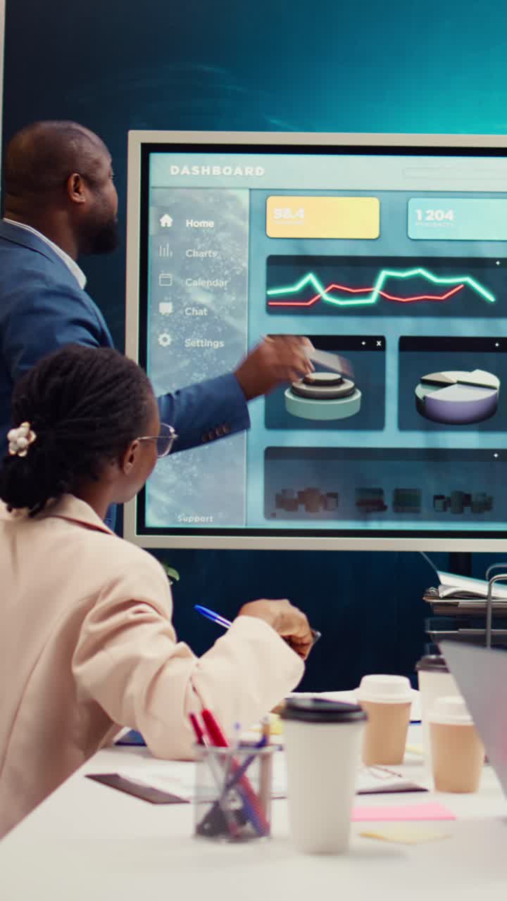 African American Business Professionals Analyzing Data on Digital Screen in Office Meeting