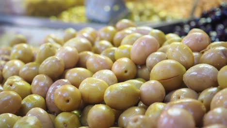 pile of green olives at a market