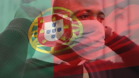 animación de la bandera de portugal ondeando sobre un hombre afroamericano con máscara facial en la calle de la ciudad