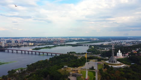 flying over the city center of ukraine's capital, historical place with a huge ukrainian flag and motherland monument