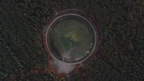 Top-down-aerial-at-Pyramid-of-Austerlitz,-above-Dutch-monument-in-woods