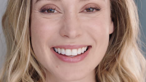 portrait beautiful caucasian woman looking in mirror at perfect skin enjoying natural complexion smiling confidently getting ready at home