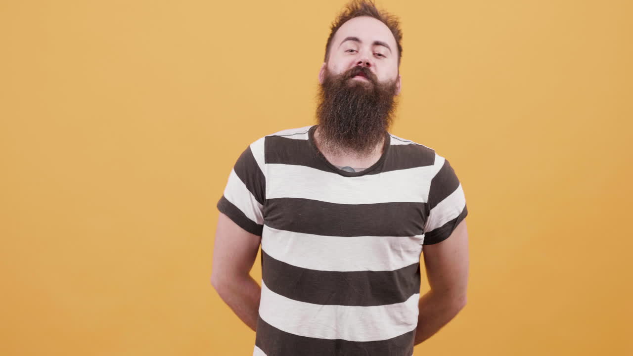 Man with Beard Posing in Front of Yellow Background