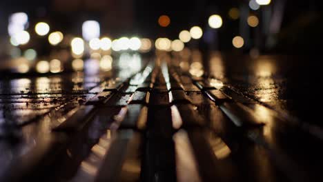 blurred view of cars traffic and lights along wet urban street road at night