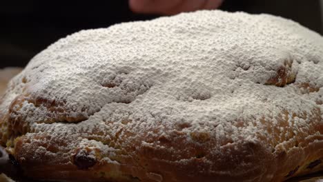 deliciously crafted pastry: a close-up view of a freshly baked sweet bread topped generously with powdered sugar, ready to delight any dessert lover