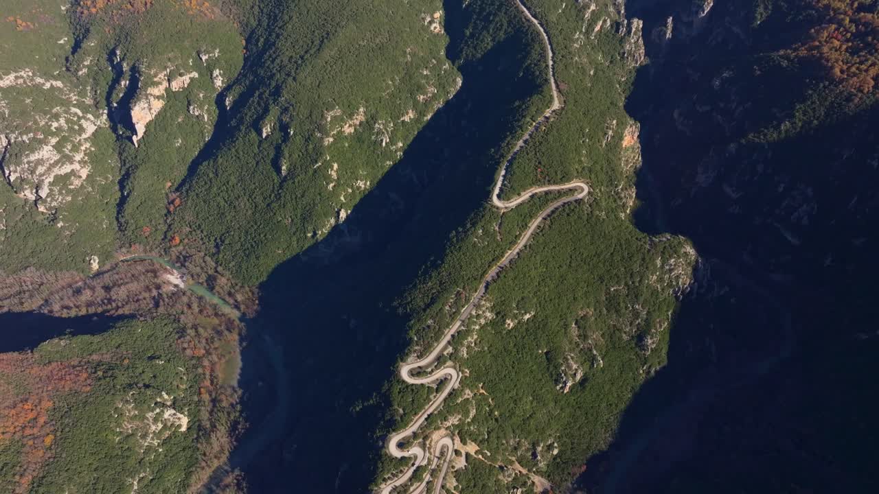 Drone perspective of traffic winding through green Papigko landscape