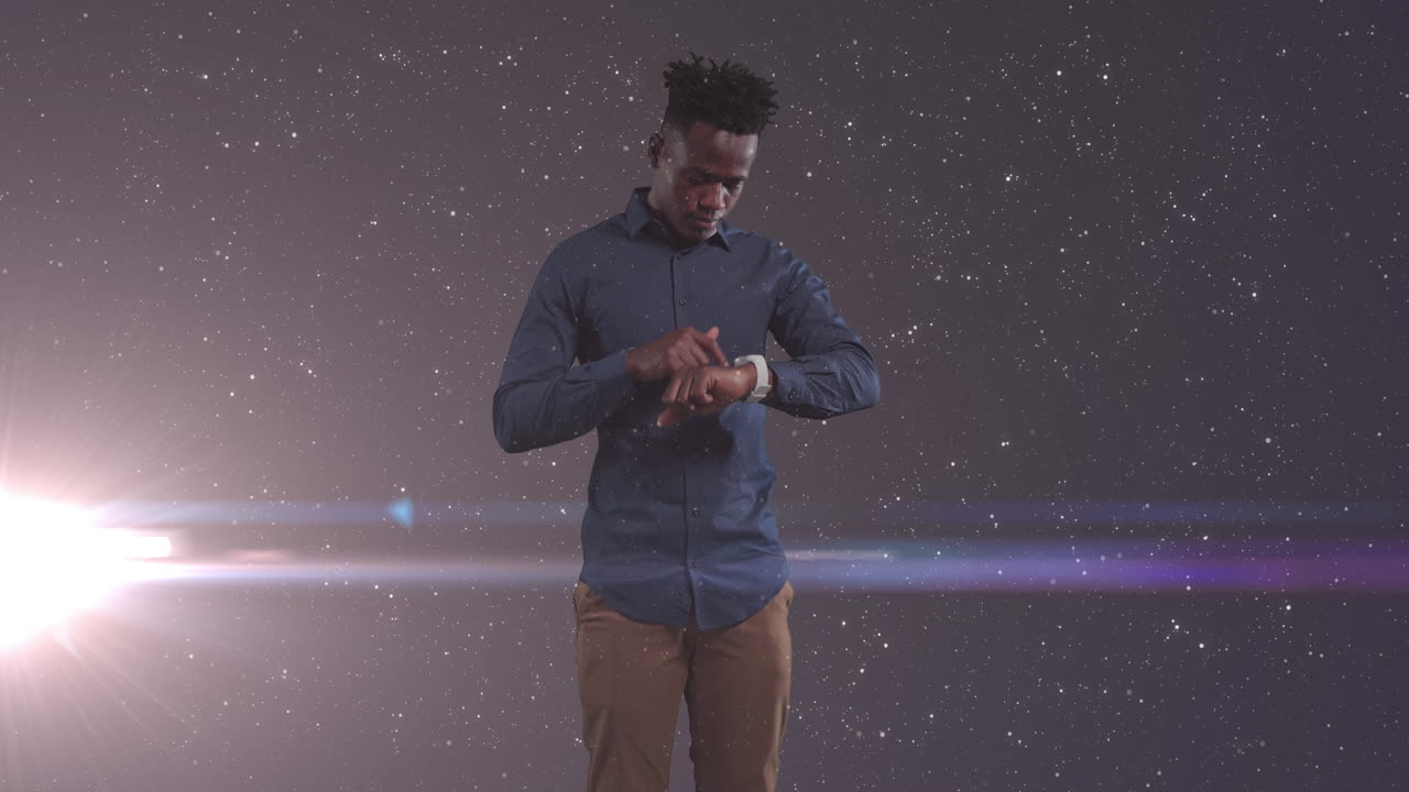 Animation of african american businessman using smartphone over glowing stars
