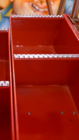 red metal trays of a carnival or arcade game