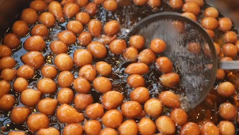 close up of lokma, a turkish sweet, being cooked in a pan