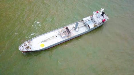 top view bird eye drone shot of cargo ship in cloudy weather