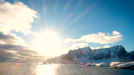 abstract lofoten sunset time lapse with the shining setting sun and  clouds floating above sea