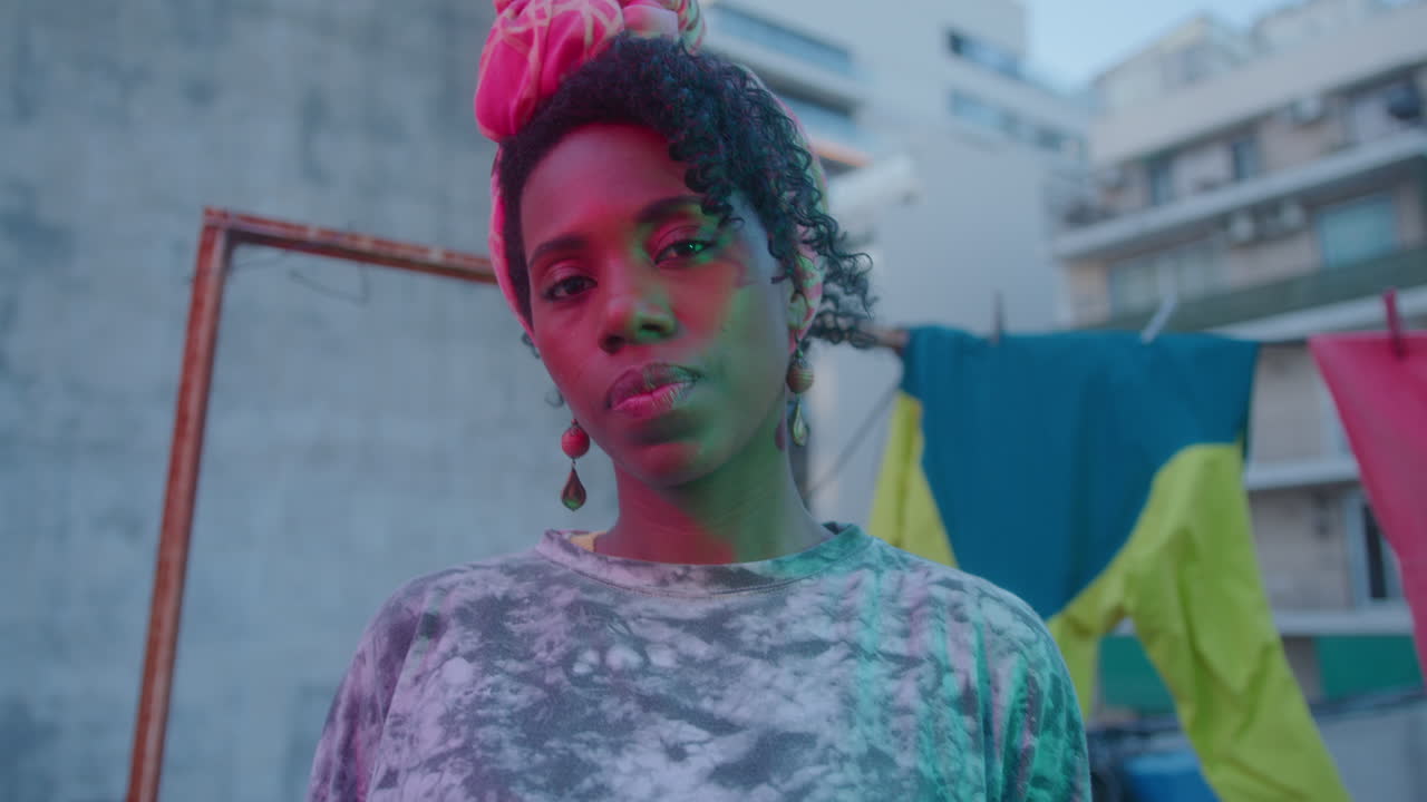 Portrait of Beautiful African-American Woman in Neon Light on Urban Rooftop