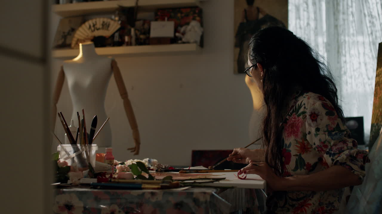 Painter creates art in serene studio setting, focused and inspired