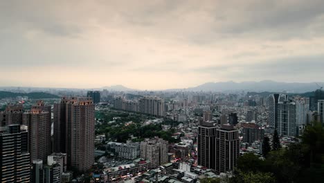 Xindian-District-Taipei-City-surrounded-by-Mountains,-outskirts-of-Taipei,-Beautiful-Aerial-Drone-Taiwan-at-Sunset-Twilight-Dusk