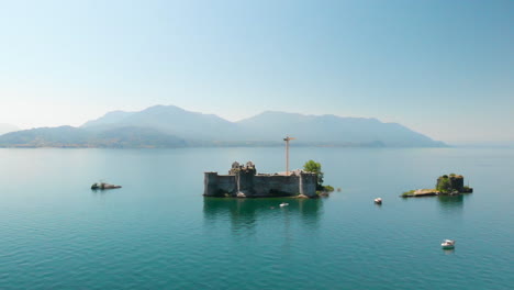 Aerial-crane-shot-of-a-ruin-in-the-middle-of-Lake-Maggiore,-Italy