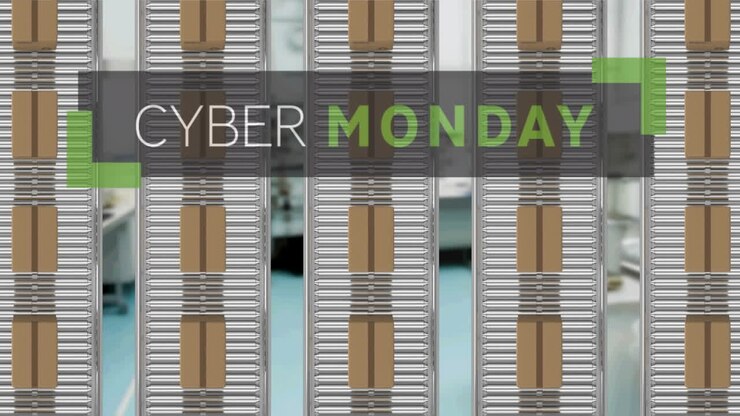 Animation of cyber monday text over cardboard boxes on conveyor belts in warehouse
