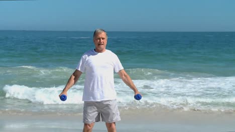 Elderly-man-working-his-muscles-with-dumbbells