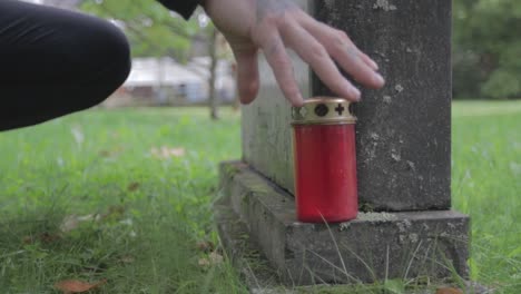 graveyard candle set down with an tattoo hand