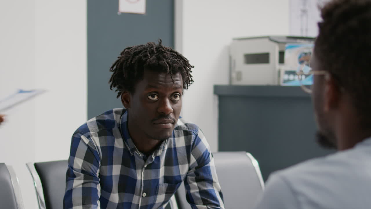 African american men talking in facility waiting room